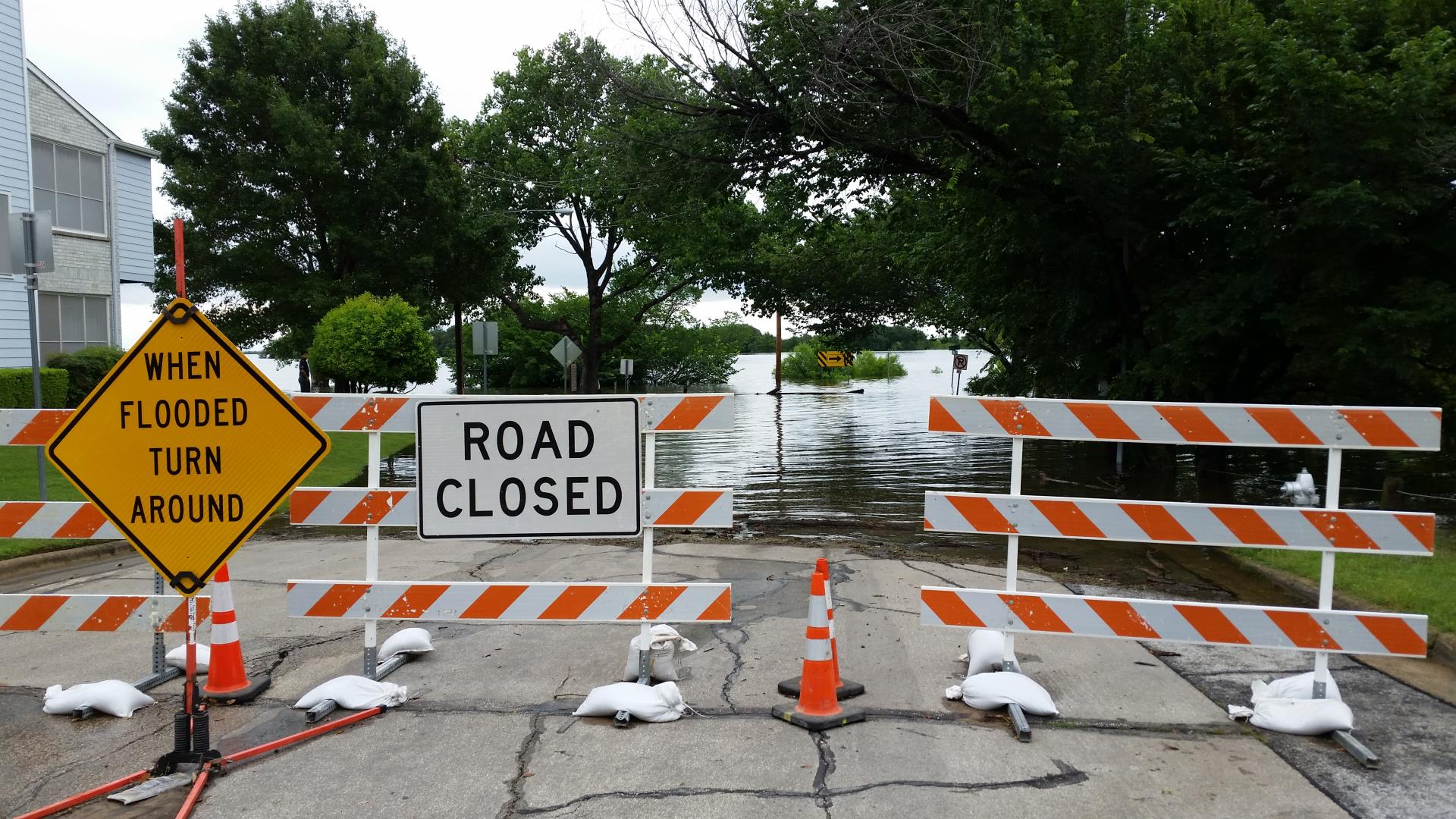 flooded street with road closed sign