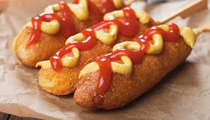 picture of corny dogs with ketchup and mustard