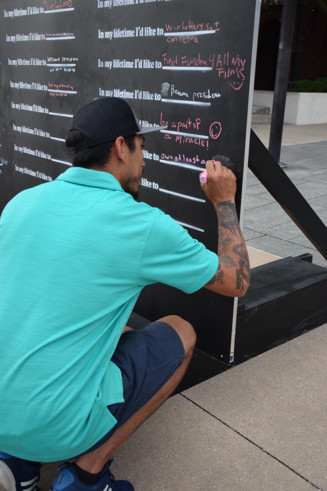 Man signing lifetime wall 2